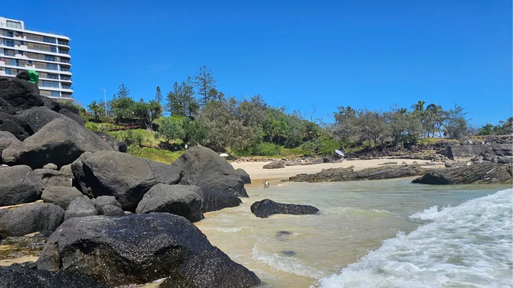 Froggies Beach Coolangatta showing the rocky shoreline and nearby high-rise buildings