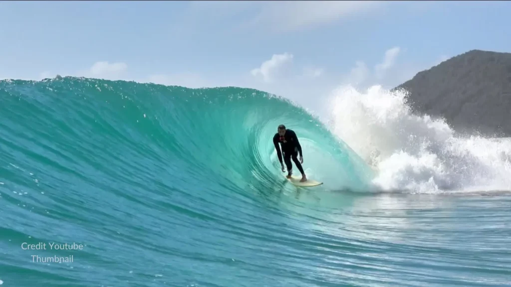 Surfer riding a wave on K’gari Fraser Island Queensland