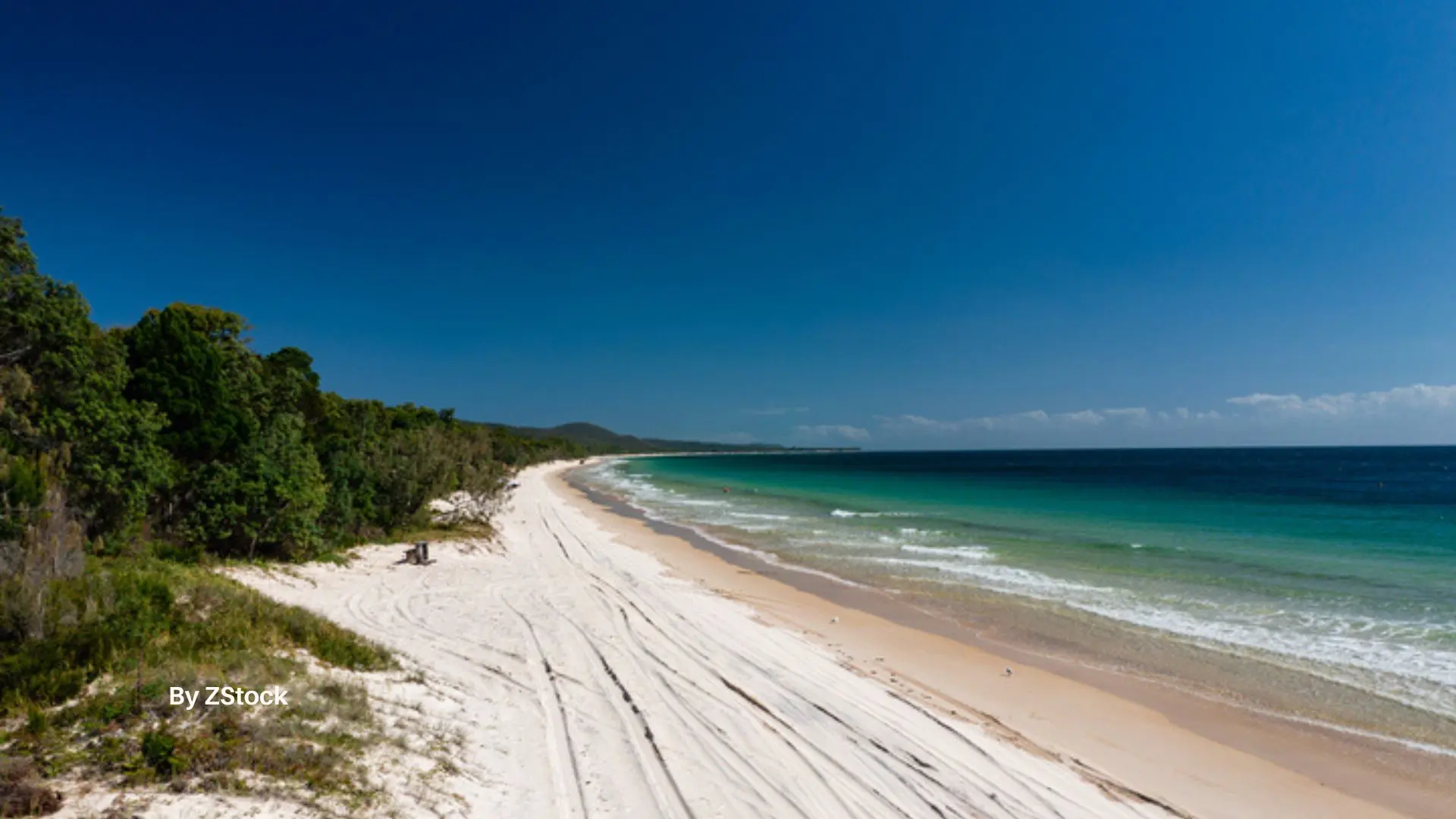 Surfer riding a wave on K’gari Fraser Island Queensland